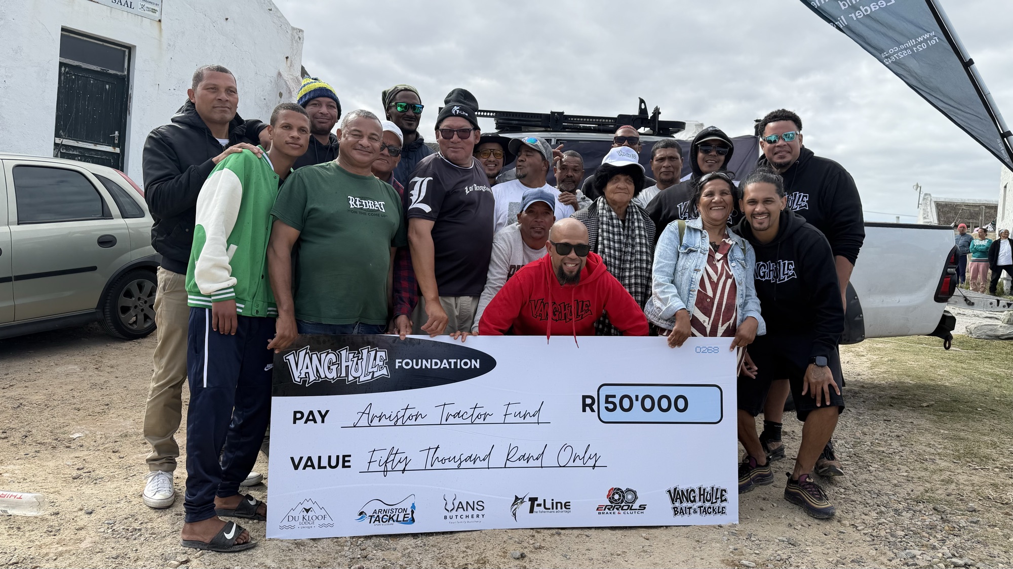 The Vang Hulle crew with the Kassiesbaai fishing community holding the R50 000 cheque for the Arniston Tractor Fund